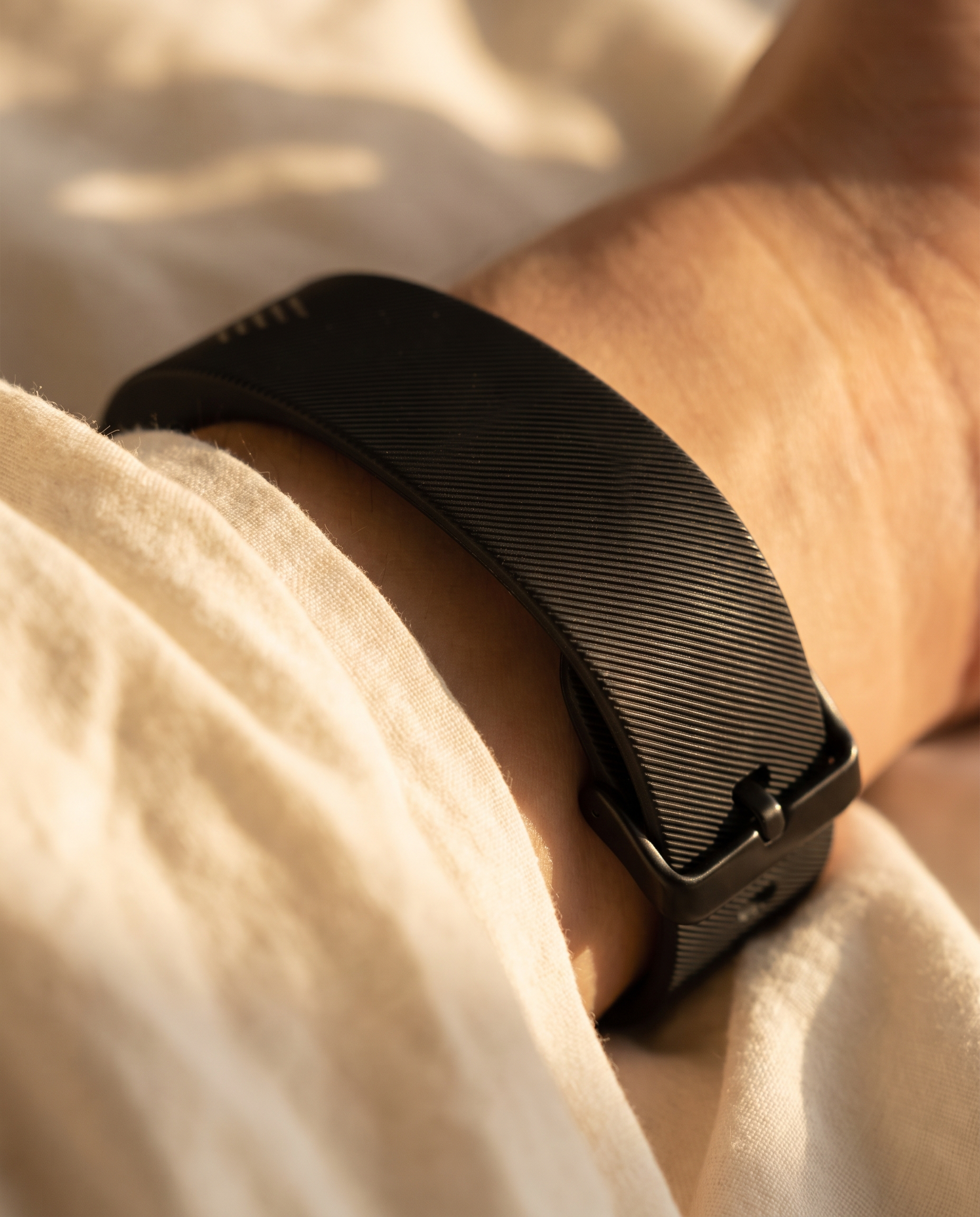 Macro close-up of the Rouzu band on a wrist at sunrise